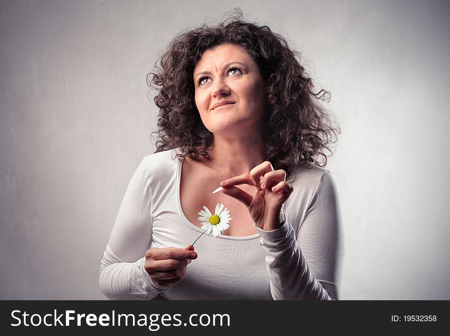 Smiling woman wavering a daisy. Smiling woman wavering a daisy