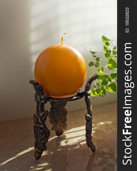 Classic candlestick with an orange candle