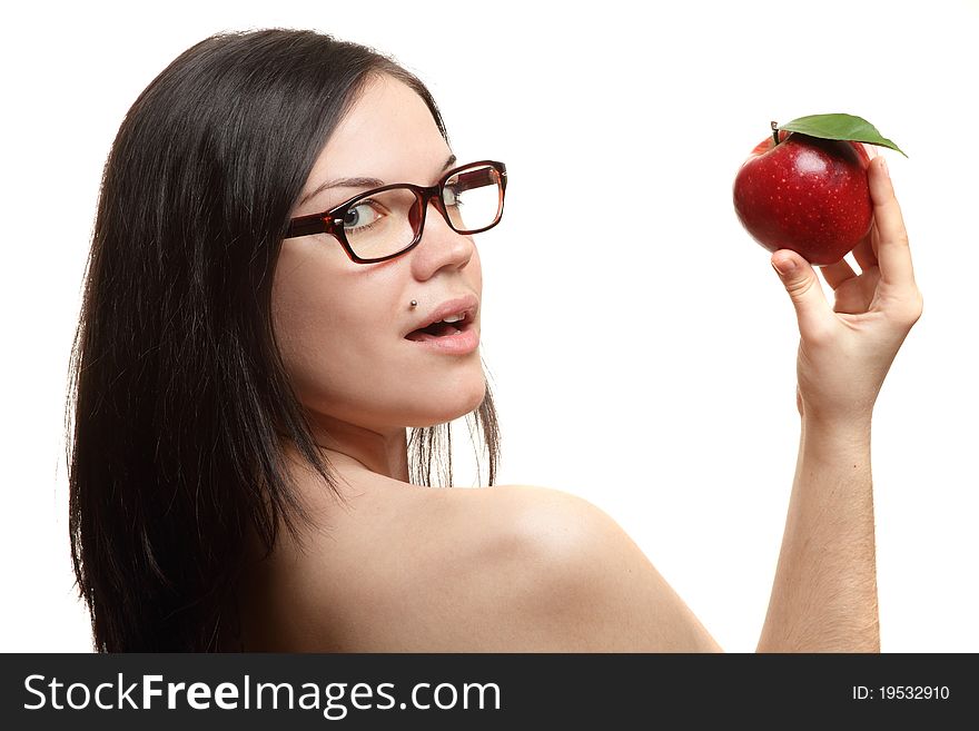 The beautiful girl wearing spectacles with an apple in a hand on a white background