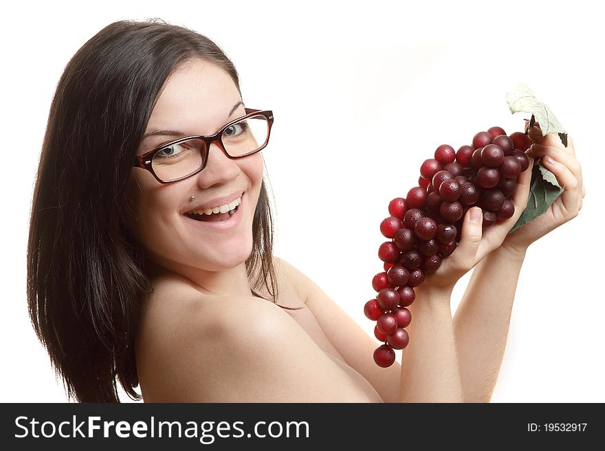 The beautiful girl of grapes wearing spectacles with a cluster on a white background