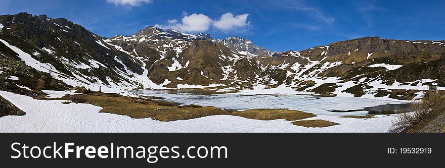 Mountain frozen lake in spring on alps in spring. photo taken in may at 2000 meters on the sea level.