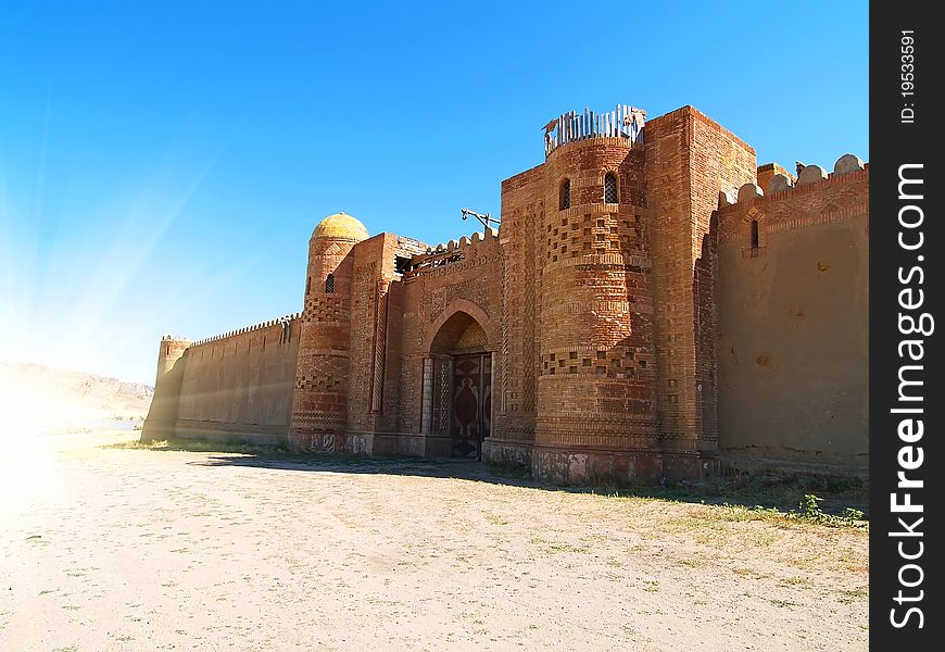 Ancient gates and wall in the mountains under blue sky