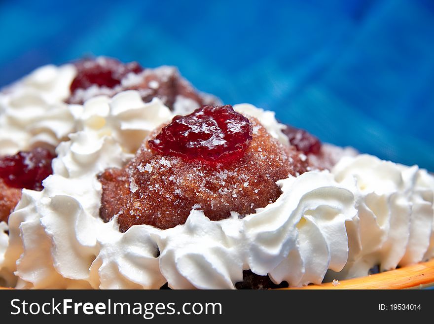 Strawberry jam filled doughnuts with cream and castor sugar. Strawberry jam filled doughnuts with cream and castor sugar