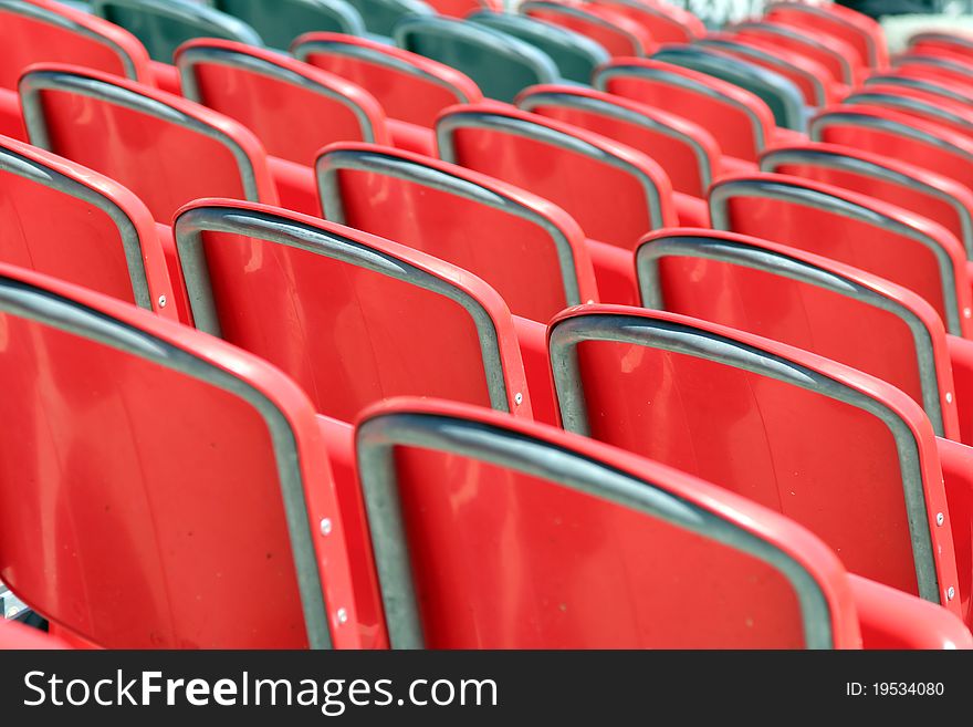 Red plastic stadium seats - back view
