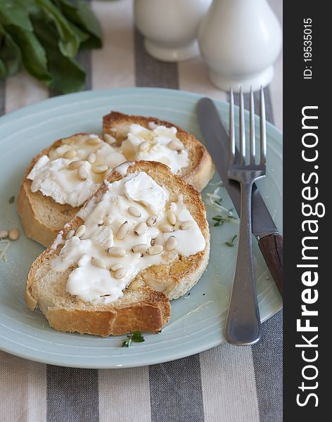 Sourdough with goat's cheese, pine nuts and honey. Sourdough with goat's cheese, pine nuts and honey