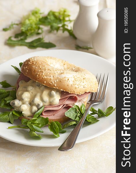 Freshly baked bagel filled with pastrami, watercress and dressing. Freshly baked bagel filled with pastrami, watercress and dressing