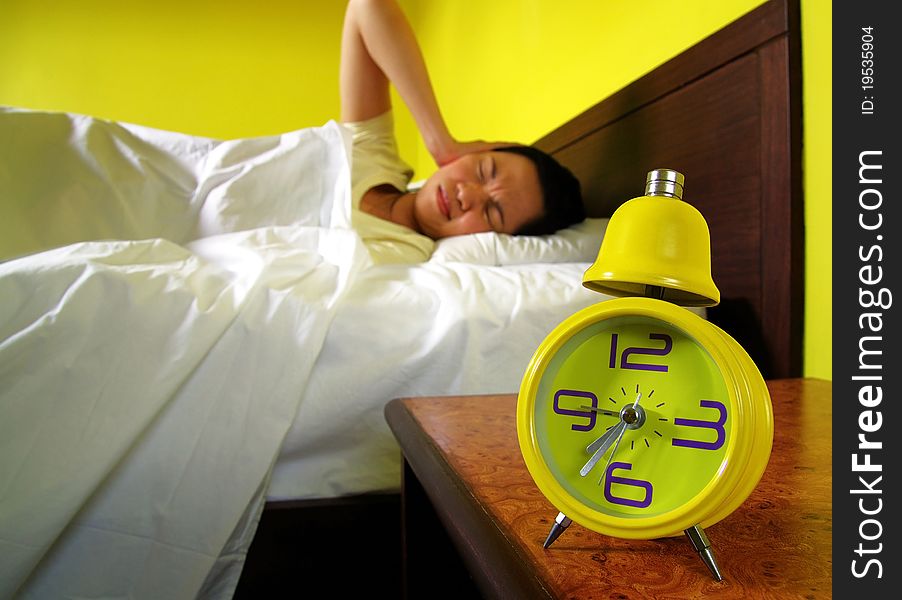 Woman and alarm clock in bedroom. Woman and alarm clock in bedroom