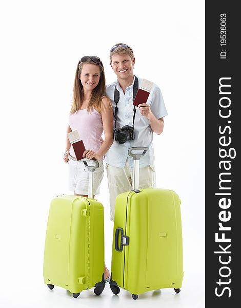 Attractive young couple with suitcases and passports isolated. Attractive young couple with suitcases and passports isolated