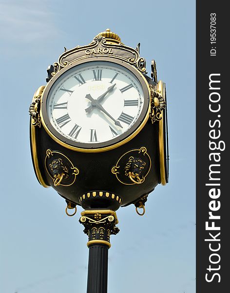 Image of a old fashion clock showing time in the middle of town. Image of a old fashion clock showing time in the middle of town