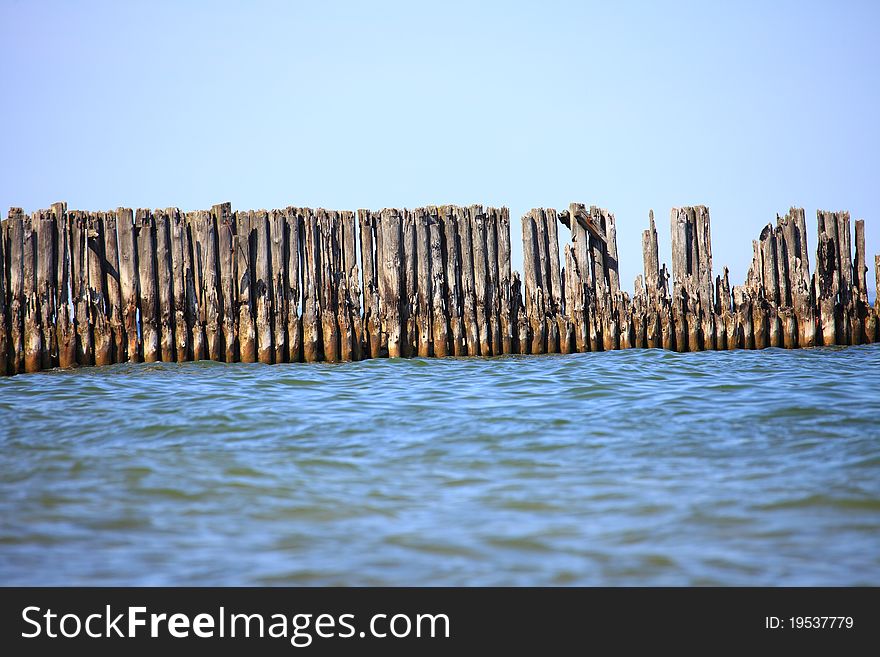 Pales of a breakwater - sea and blue sky