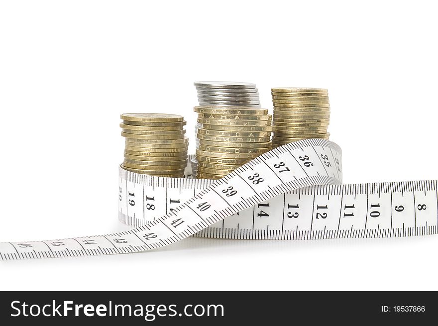 Stack of coins and tape measuring isolated on white