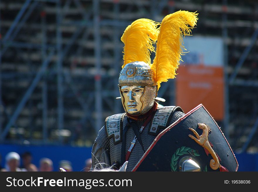 Roman soldier in the tournament with a parade mask