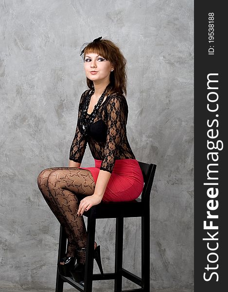 Cute gothic girl sitting on chair studio shot