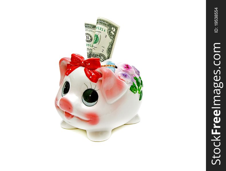 Piggy bank and $ 2 bill on white background close up