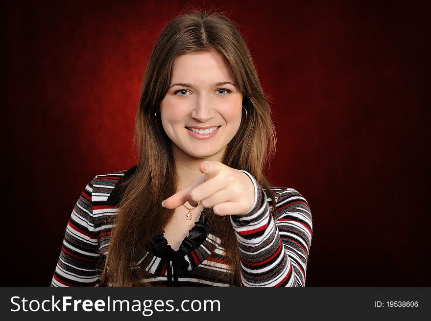 Girl pointing at you, isolated on red background