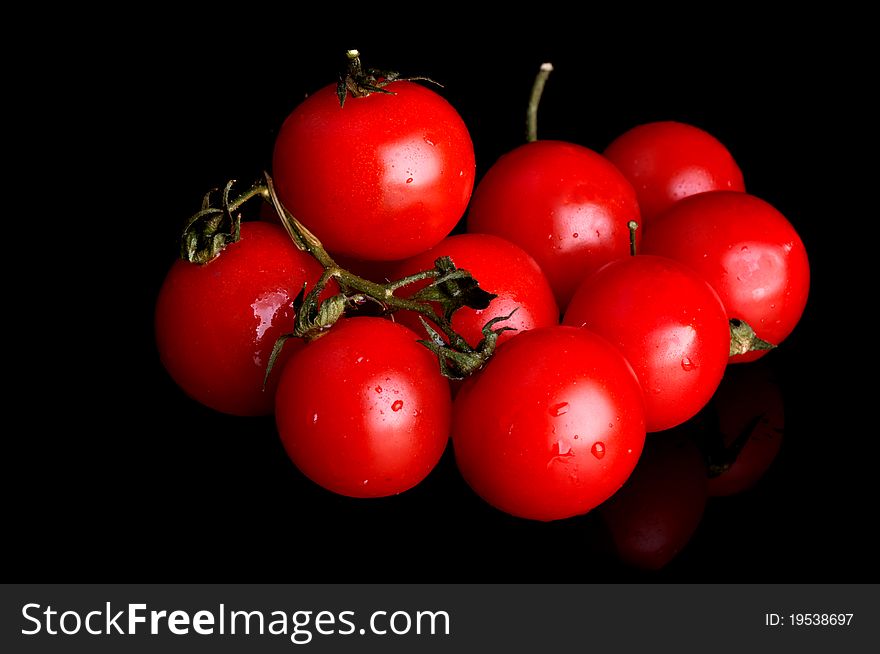 Red cherry isolated on a black background