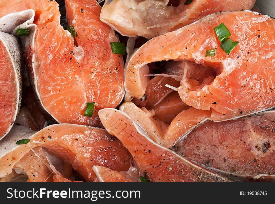 Chopped pieces of red fish on background