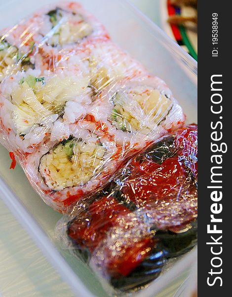 Pieces of sushi with salmon in the preservative film