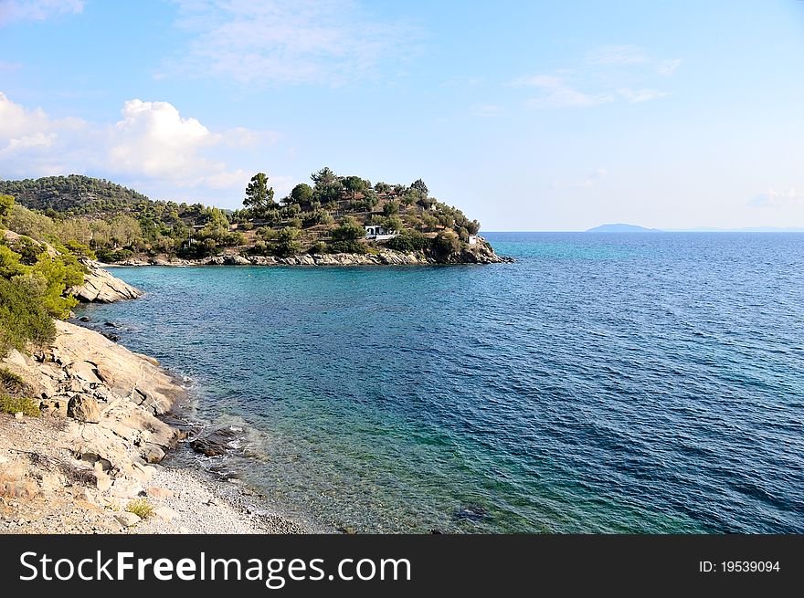 Small peninsula in the mediterranean sea, under the summer sun.