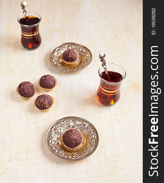 Chocolate dessert with tea in turkish glass. Chocolate dessert with tea in turkish glass