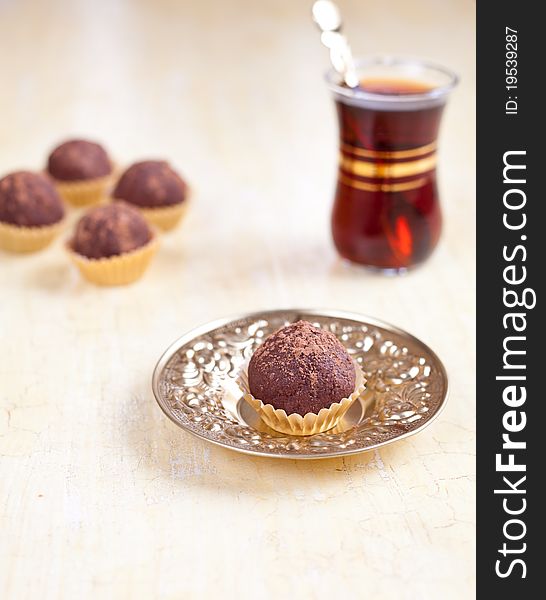 Chocolate dessert with tea in turkish glass. Chocolate dessert with tea in turkish glass