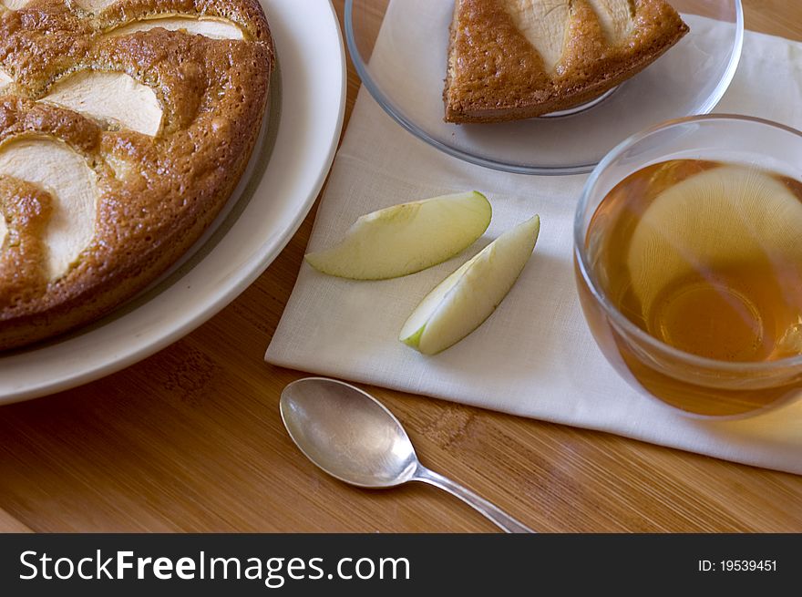 Apple pie and tea cup on table