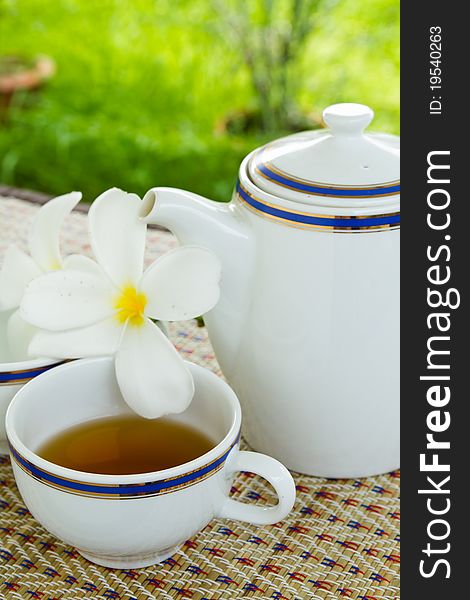 Cup of tea on a weaved mat in the garden. Cup of tea on a weaved mat in the garden