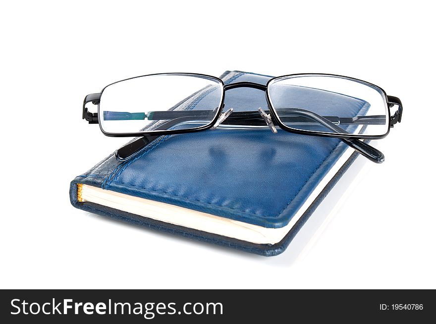 Blue Notebook And Glasses