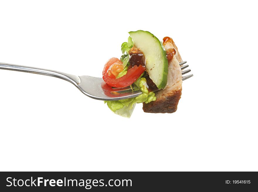 Pork pie, pickle and salad on a fork isolated against white. Pork pie, pickle and salad on a fork isolated against white