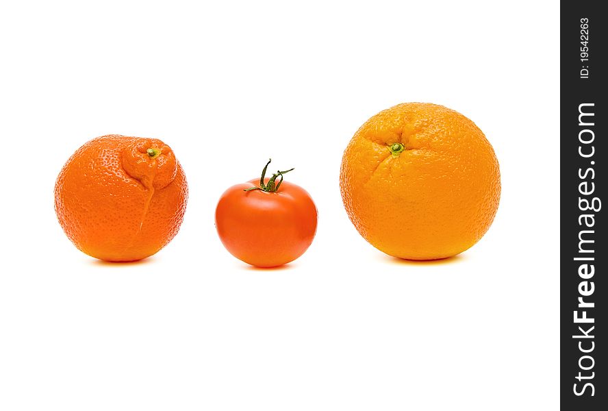 Tangerine, tomato and orange closeup on white background. Tangerine, tomato and orange closeup on white background