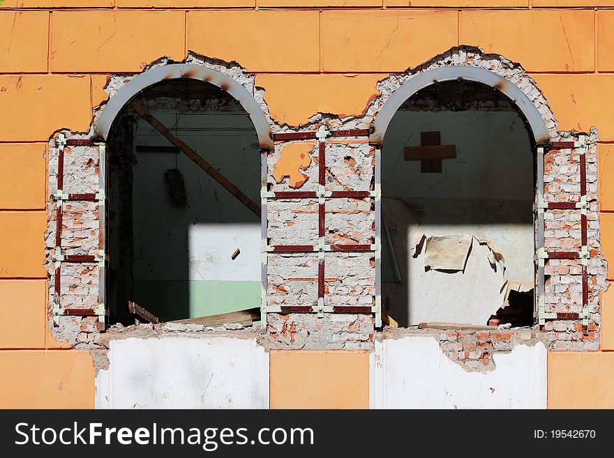 The broken windows of an old house in the process of repair. The broken windows of an old house in the process of repair