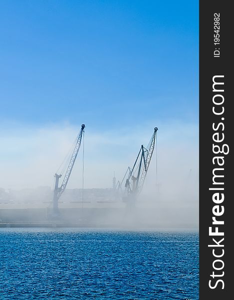 Dockyard cranes in the early morning mist. Dockyard cranes in the early morning mist