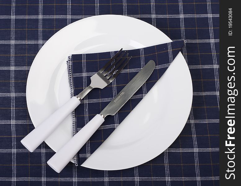 Tableware on a napkin lying in a plate