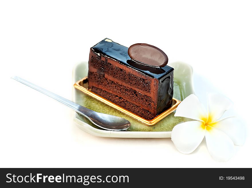 Chocolate cake with spoon and flower