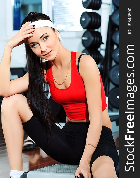 Two young sporty woman in the gym centre.