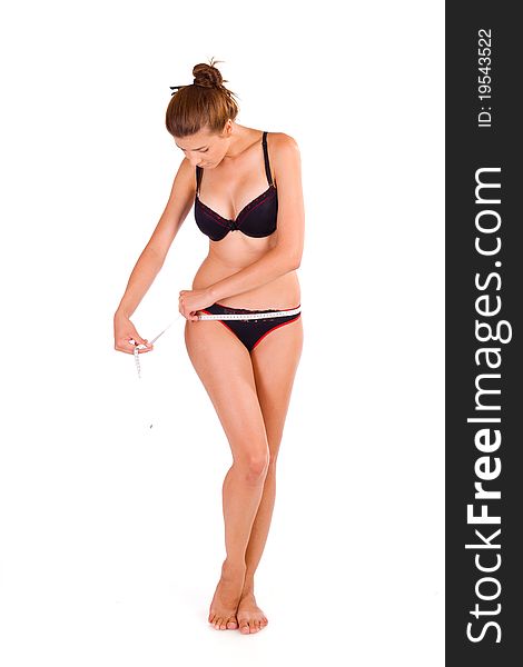 Young Caucasian woman measuring her slim body