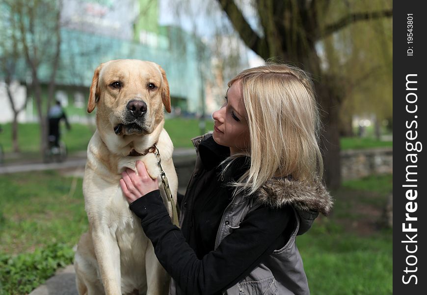 Beautiful Woman With Dog In The Park