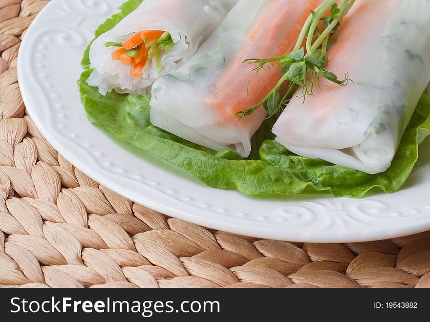 Fresh tasty spring rolls with carrot, rice noodles and sprout of green pea. Fresh tasty spring rolls with carrot, rice noodles and sprout of green pea.