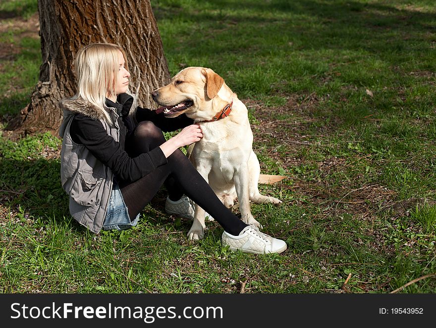 Outdoor shot of beautiful cheerful woman with dog in the park. Outdoor shot of beautiful cheerful woman with dog in the park