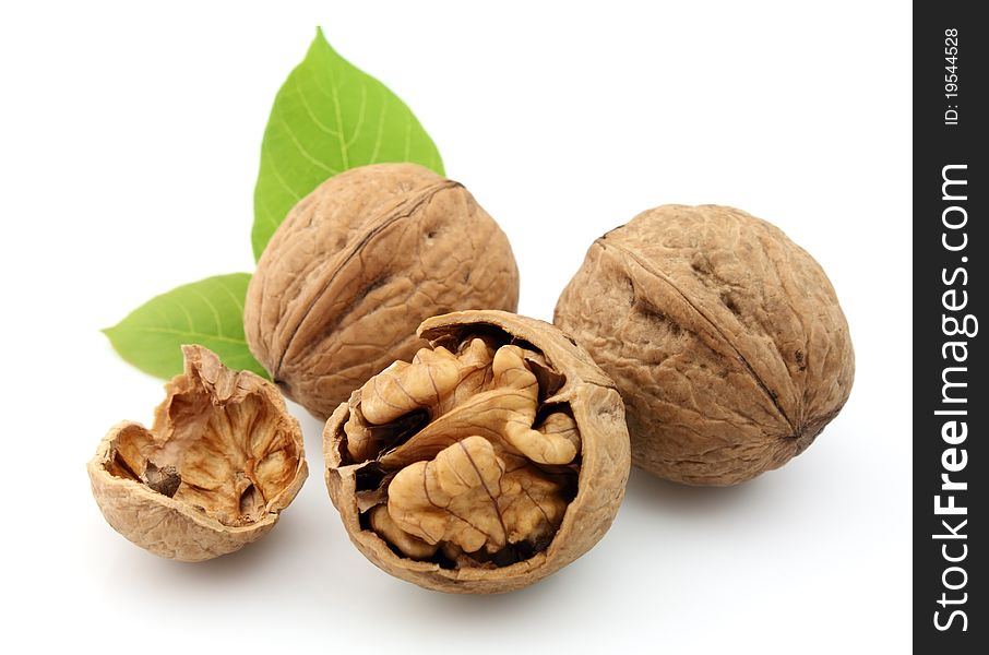 Walnuts with leafs on a white background