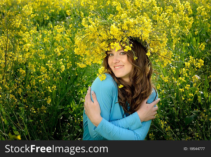 Beautiful young woman on rapeseed field