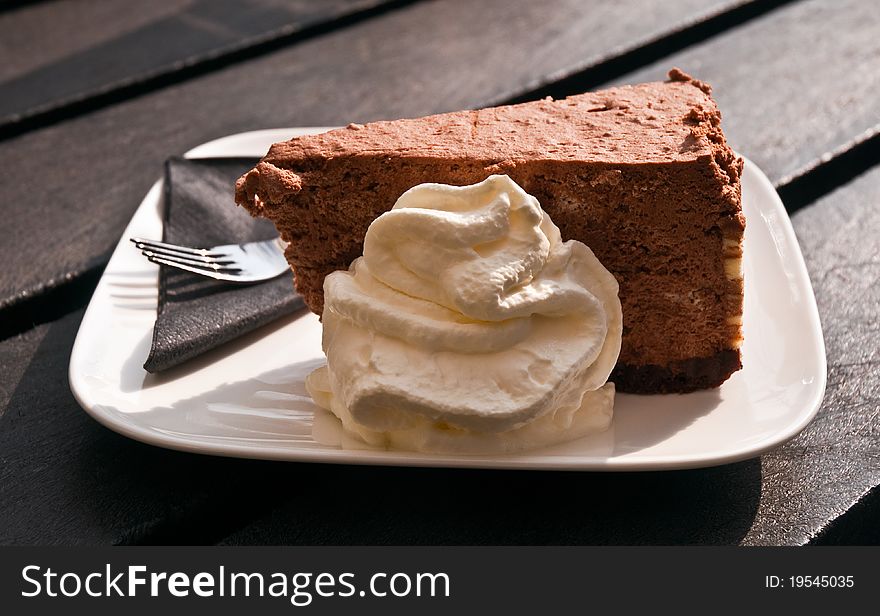 Piece of chocolate cake with whipped cream. Piece of chocolate cake with whipped cream.