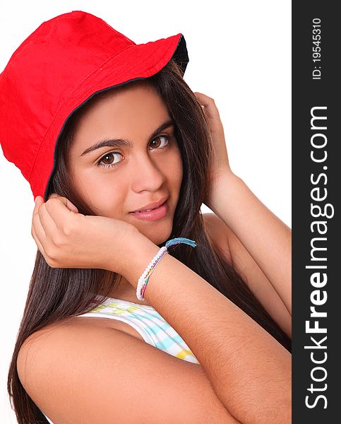 Beautiful woman with a red cap on her head with her hands holding it