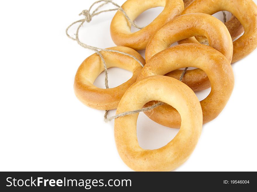 Many bagels tied with rope. Isolated on white background