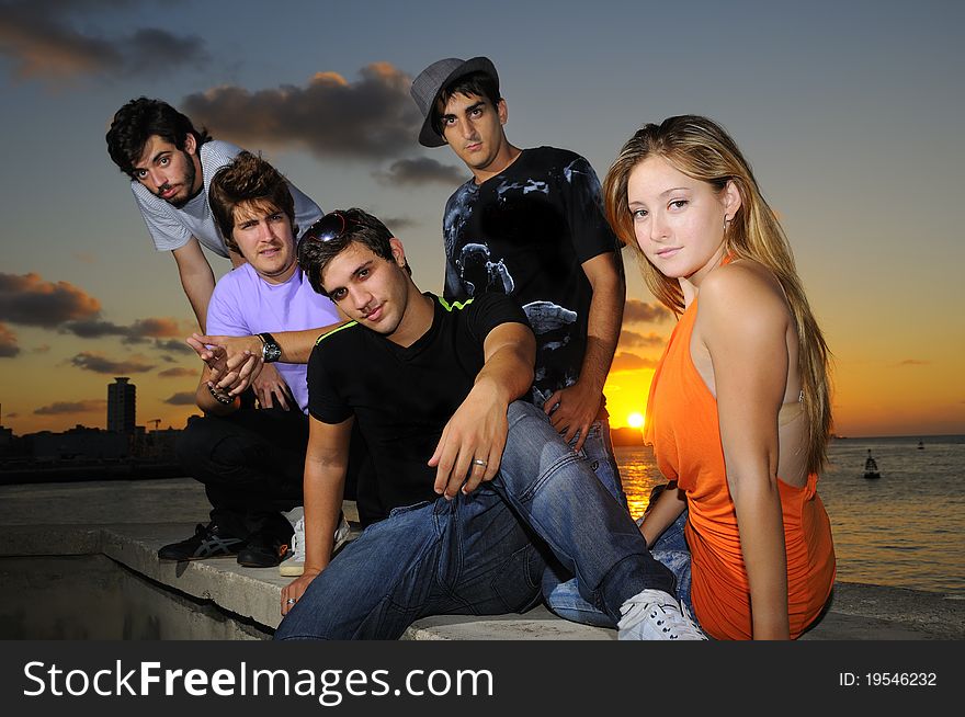 Diverse young team posing at sunset