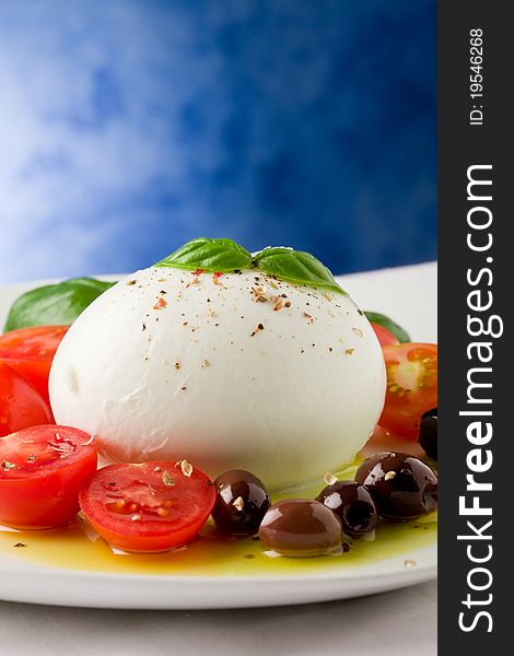 Deliciious buffalo mozzarella with cutted cherry tomatoes and olives over extra vergin oil. Deliciious buffalo mozzarella with cutted cherry tomatoes and olives over extra vergin oil