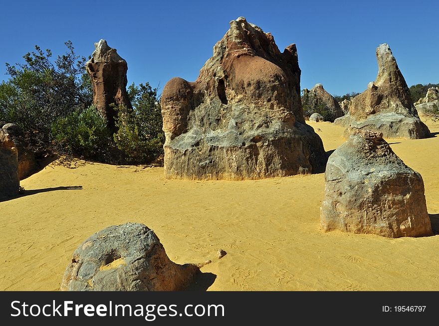 Sedimentary rocks tower over the sand at the Pinnacles in western Australia.