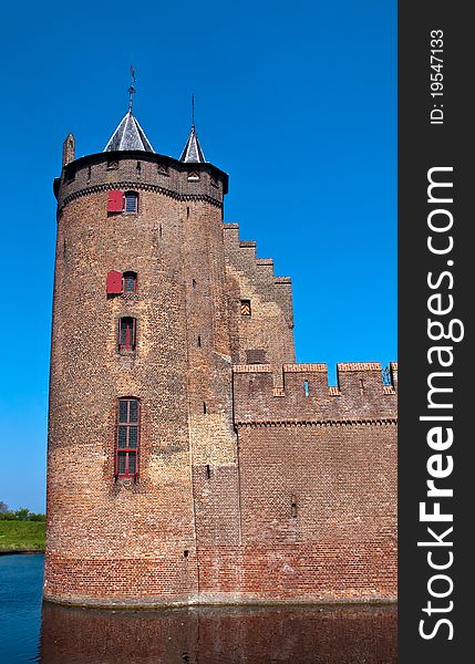 Old Dutch castle and running beside him a woman dressed in national costume 16 th century. Old Dutch castle and running beside him a woman dressed in national costume 16 th century.