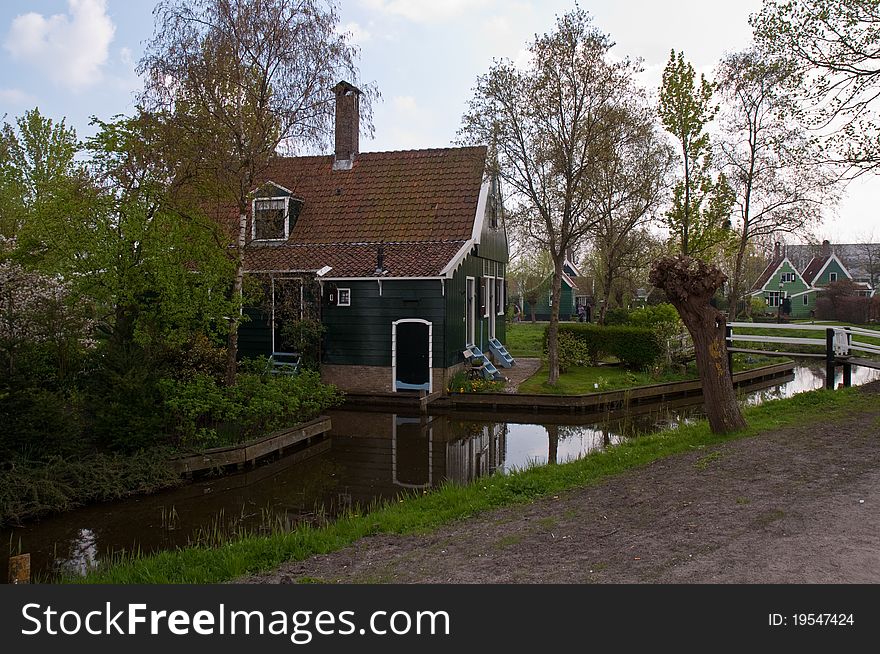 Typical Dutch landscape - houses along the canal. Typical Dutch landscape - houses along the canal.