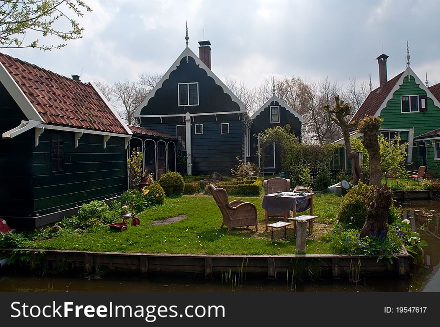 Typical Dutch landscape - houses along the canal. Typical Dutch landscape - houses along the canal.